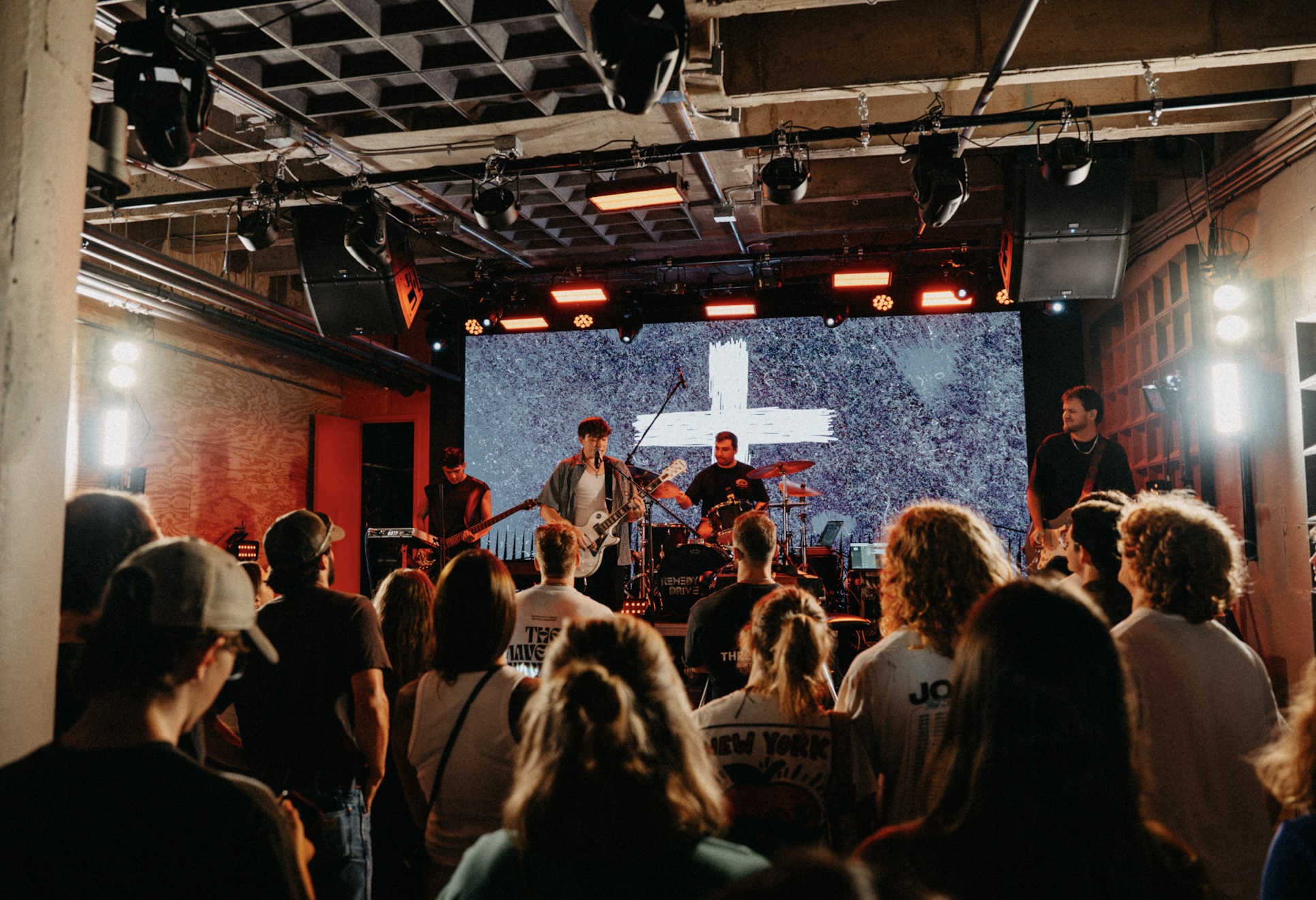 roo and the band performing live for a packed room